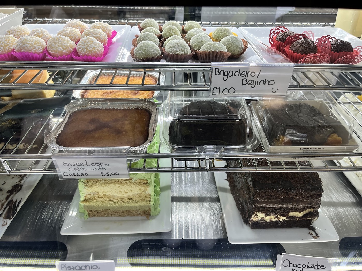 Lakcakes display counter in Stratford with brigadeiro, coconut beijinho, sweetcorn cake, carrot cake and chocolate cake