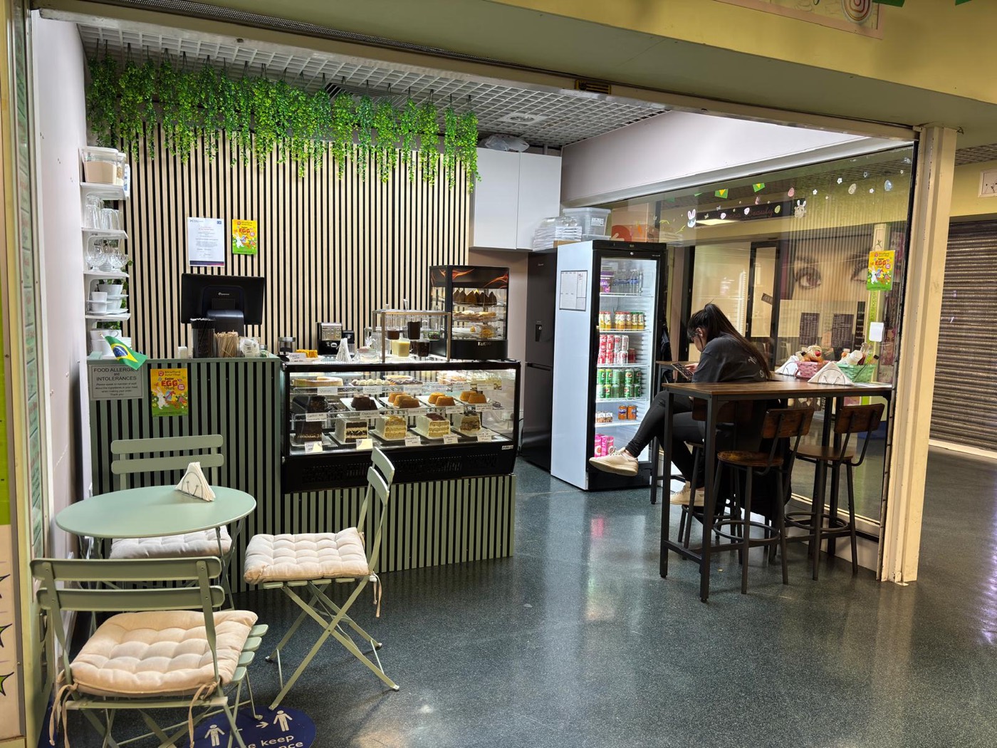 Inside Lakcakes — the counter and seating in Stratford Market Village